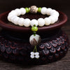 White bodhi seed bracelet with a carved lotus flower charm