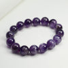 Natural amethyst bead bracelet in deep purple on a white surface