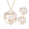 Pearl camellia pendant necklace and matching stud earrings with white petals in gold-tone flower frames