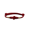 Red braided cord bracelet with a central knot and gold accents
