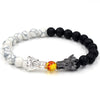 Beaded bracelet with dragon charm, black lava rock and white stone beads