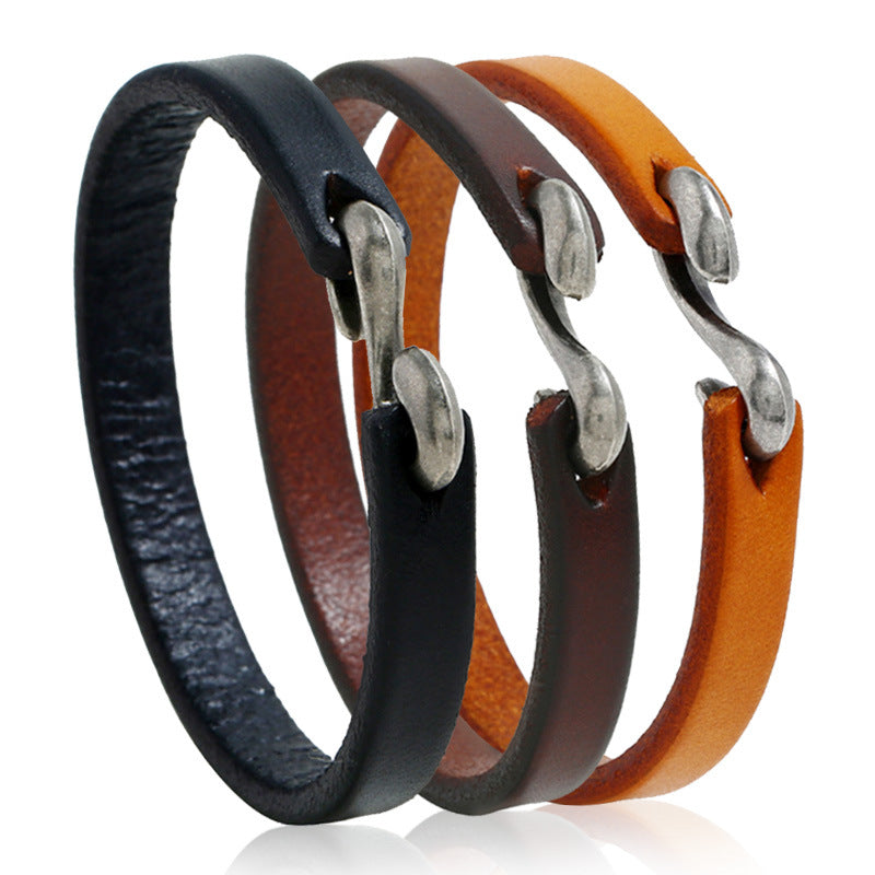 Three vintage leather bracelets in black, brown, and tan with silver-tone buckles
