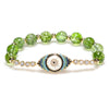Olive green crystal bracelet with gold evil eye charm on white background