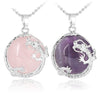 Two Chinese Dragon pendants, one in pink Rose Quartz and one in purple Amethyst, on silver-tone chains.