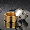 Close up of a gold tone and silver tone rotating ring with mantras engraved on the surface