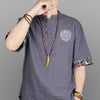 Long wood bead necklace with a yellow horn shaped pendant worn on a model