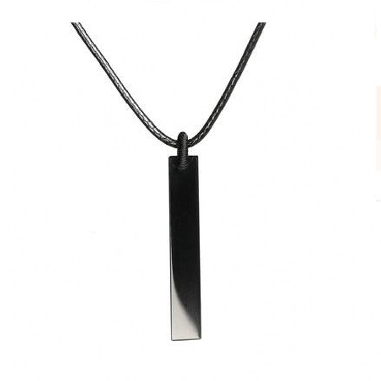 Minimalist black obsidian crystal pendant hanging on a thin black cord