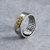 Close-up of a silver-plated ring with a gold-tone Pixiu charm and engraved text inside