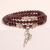 Triple wrap garnet bead bracelet with silver tone bean charm
