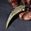 Close up side view of the carved gold obsidian wolf tooth pendant showing detailed texture.
