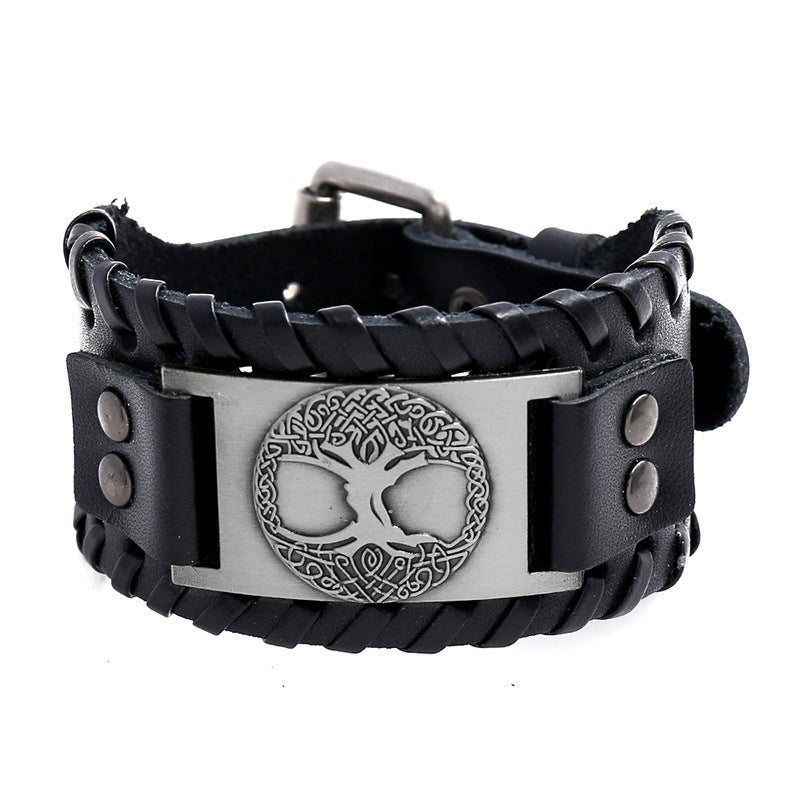 Close up of black leather bracelet with silver tree of life plate