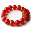 Close-up of a red agate beaded bracelet with a carved Pixiu charm