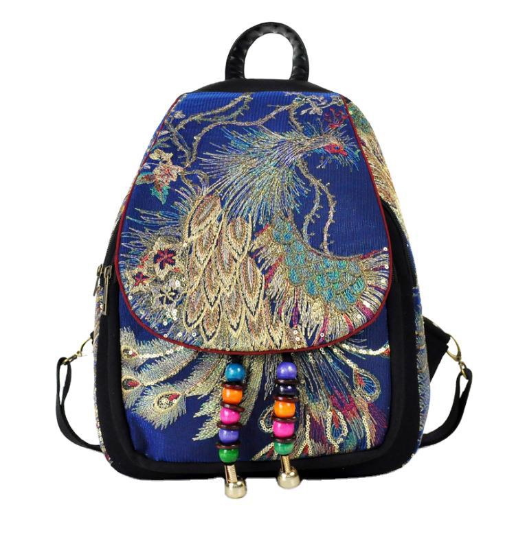 Blue canvas backpack with gold peacock embroidery and colorful bead tassels