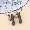 Three variations of an ebony wood cylinder necklace with colorful charms on a beige background
