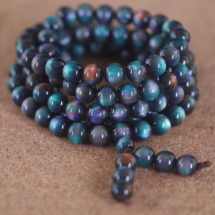 Coiled blue resin mala bracelet with cat eye effect on textured surface