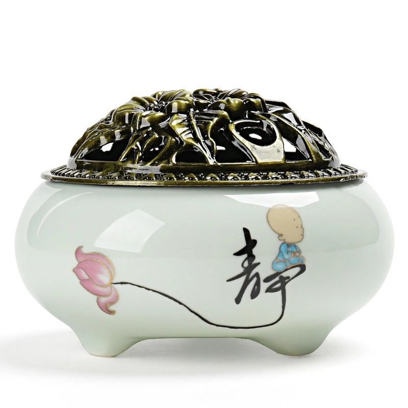 White ceramic incense burner with a lotus design and metal lid