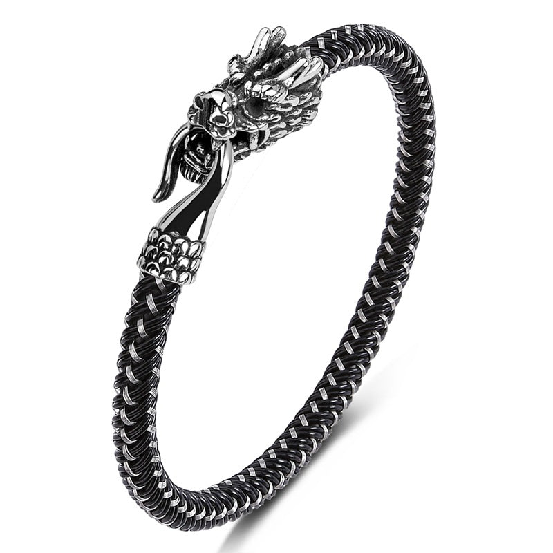 Polished silver-tone titanium steel bracelet with a detailed dragon head clasp on a black braided band.