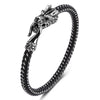 Polished silver-tone titanium steel bracelet with a detailed dragon head clasp on a black braided band.