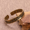 Antique style copper open cuff bracelet with Sanskrit mantra and floral totem details