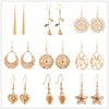 Gold-tone copper drop earrings with an openwork leaf design