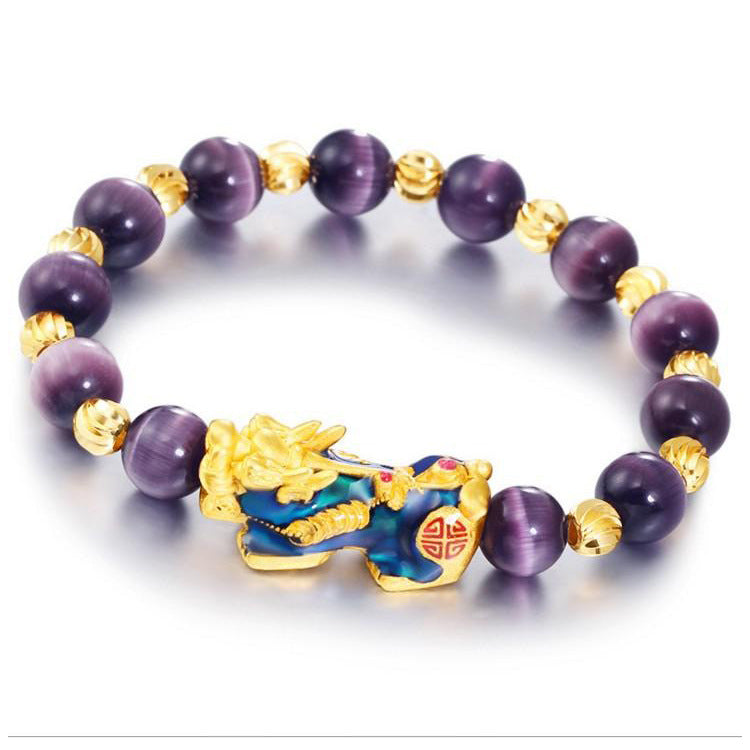 Gold-tone Pixiu charm on a purple cat eye beaded bracelet