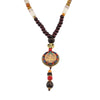 Close up of a round Thangka pendant hanging from a dark wood bead necklace