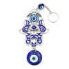 Silver-tone Hamsa hand keychain with blue glass and glass evil eye beads on a white background