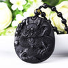 Close-up of a black stone pendant carved with a dragon design