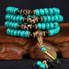 Coiled turquoise mala necklace with black and white Dzi beads and gold-tone charms