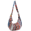 A colorful cotton shoulder bag with a floral pattern hanging against a white background