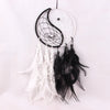 Black and white Yin Yang dream catcher hanging against a white background
