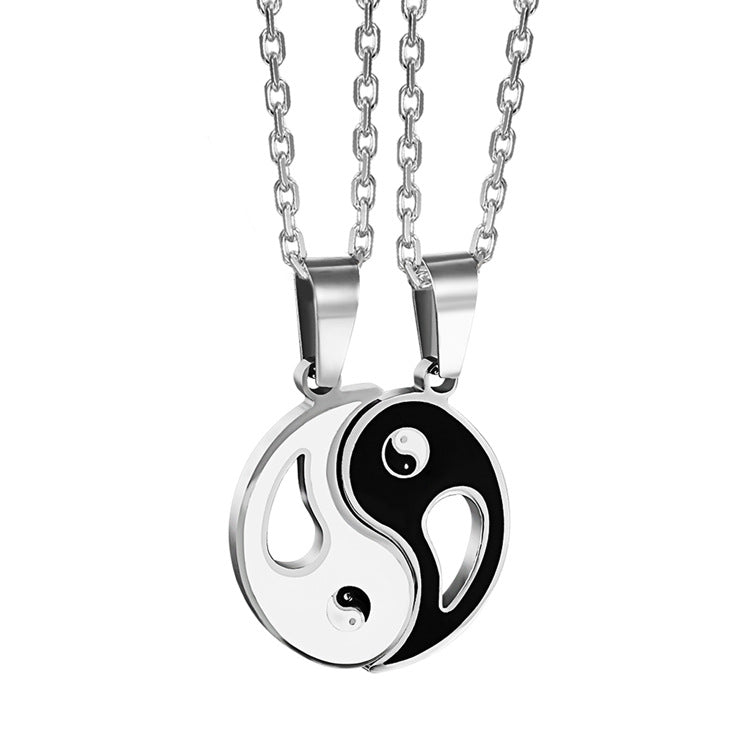 Two silver-tone necklaces with black and white Yin Yang pendants side by side