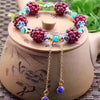 Garnet Cluster Bracelet with Gold-Tone Chain and Floral Accents