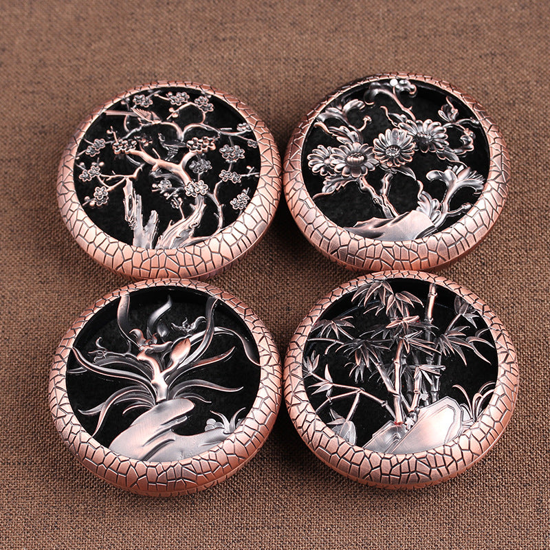 Round metal incense burners with floral and plant cutouts in antique finishes