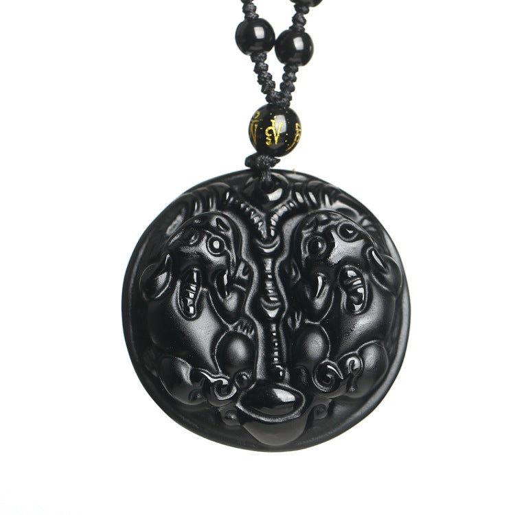 Black obsidian necklace with a carved double pixiu pendant on a beaded cord