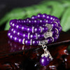 Triple wrap purple chalcedony bracelet with silver Pixiu charm on wood