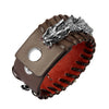 Close-up of a brown woven leather bracelet with a silver dragon head charm.