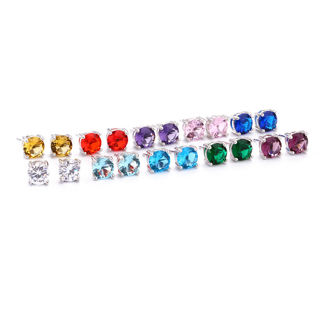 A pair of round gemstone stud earrings with silver four-prong setting