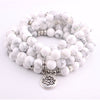 White turquoise beaded mala bracelet with silver lotus charm