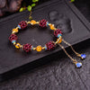 Garnet Cluster Bracelet with Gold-Tone Chain and Floral Accents