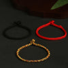 Three hand-braided bracelets in red, black, and multi-color with silver beads on a dark surface