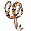 Long necklace featuring a large brown nine-eye dzi bead pendant with red and black agate spacer beads.