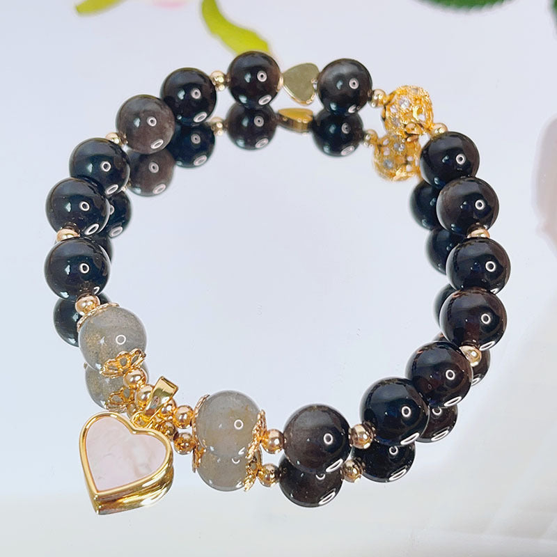 Silver sheen obsidian beaded bracelet with a gold-tone heart charm and grey accent beads