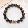 Faceted tiger eye bead bracelet with gold and silver mantra charm