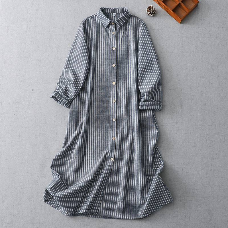 Grey-blue striped cotton linen midi dress with polo collar laid flat on a grey surface