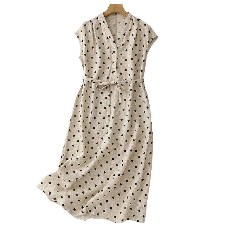 Front view of a beige sleeveless polka dot dress on a hanger