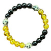 A beaded bracelet with black, yellow, and speckled white beads on a white background