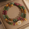 Double wrap bracelet with multicolored tourmaline beads and a white jade flower centerpiece