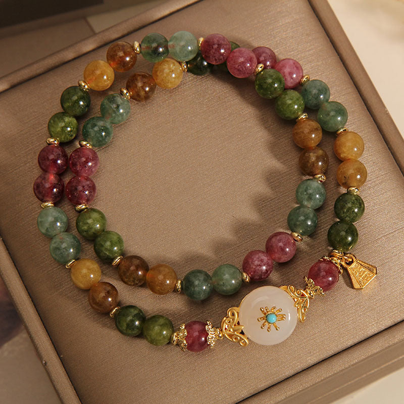 Double wrap bracelet with multicolored tourmaline beads and a white jade flower centerpiece