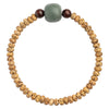Close up of a Star and Moon Bodhi seed bracelet with a green accent bead on a wrist